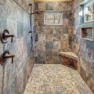 Inspiration for a mid-sized rustic 3/4 beige tile multicolored floor alcove shower remodel with shaker cabinets, medium tone wood cabinets, a one-piece toilet, beige walls, an undermount sink, a hinged shower door and beige countertops