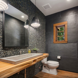 Inspiration for a mid-sized contemporary master medium tone wood floor and single-sink bathroom remodel in Seattle with a one-piece toilet and a vessel sink