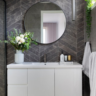 Design ideas for a mid-sized contemporary bathroom in Canberra - Queanbeyan with white cabinets, gray tile, porcelain tile, porcelain floors, an integrated sink, grey floor, flat-panel cabinets and white benchtops.