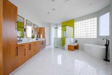 Inspiration for a large contemporary master white tile and ceramic tile cement tile floor and white floor bathroom remodel in Dallas with flat-panel cabinets, medium tone wood cabinets, a two-piece toilet, an undermount sink, granite countertops, a hinged shower door, white countertops and gray walls