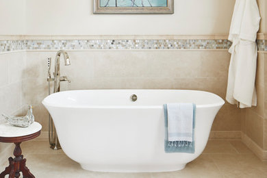 This is an example of a large classic ensuite bathroom in Austin with shaker cabinets, white cabinets, a freestanding bath, a walk-in shower, a one-piece toilet, blue tiles, glass tiles, beige walls, marble flooring, a submerged sink, engineered stone worktops, beige floors, a hinged door and beige worktops.