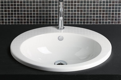 Inspiration for a contemporary bathroom remodel in Other with a drop-in sink