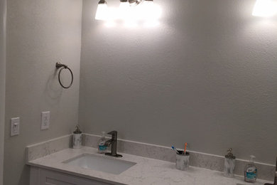 Large transitional master porcelain tile and gray floor bathroom photo in Miami with raised-panel cabinets, white cabinets, gray walls, an undermount sink, quartz countertops and white countertops