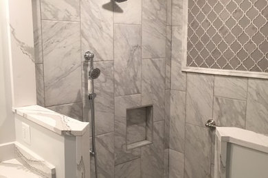 Doorless shower - large transitional master gray tile, white tile and porcelain tile mosaic tile floor doorless shower idea in Baltimore with raised-panel cabinets, dark wood cabinets, white walls, an undermount sink and quartzite countertops
