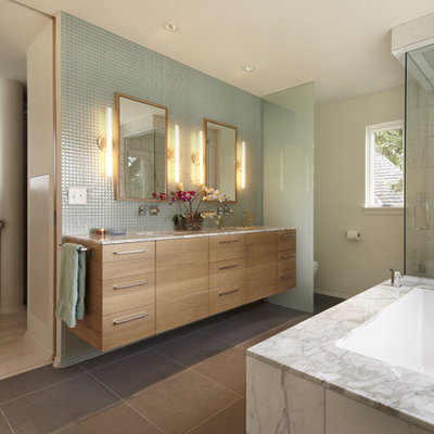 Bathroom - contemporary gray tile bathroom idea in Minneapolis with an undermount sink, flat-panel cabinets, an undermount tub and light wood cabinets