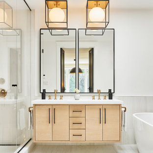 Photo of a scandinavian master bathroom in Toronto with flat-panel cabinets, light wood cabinets, a freestanding tub, white walls, white floor and white benchtops.