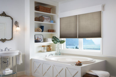 Example of a beach style drop-in bathtub design in Other with white walls and a pedestal sink