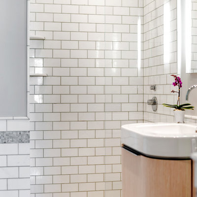 Alcove shower - small contemporary master white tile and subway tile mosaic tile floor alcove shower idea in New York with furniture-like cabinets, light wood cabinets, green walls and an integrated sink