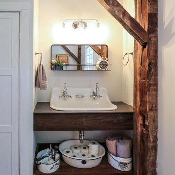 Century Home Bathroom with Farmhouse Sink and Tiled Bathtub