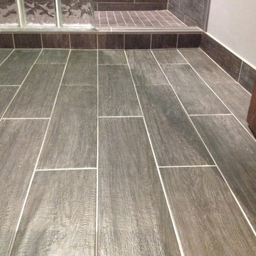 Ceramic distressed wood looking bathroom flooring in a basement remodel
