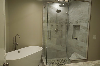 Example of a small transitional 3/4 beige tile and porcelain tile porcelain tile and gray floor bathroom design in Atlanta with shaker cabinets, white cabinets, a two-piece toilet, beige walls, an undermount sink, granite countertops and a hinged shower door