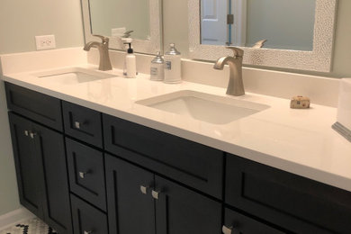 Mid-sized master bathroom photo in Charlotte with an undermount sink, quartz countertops and white countertops