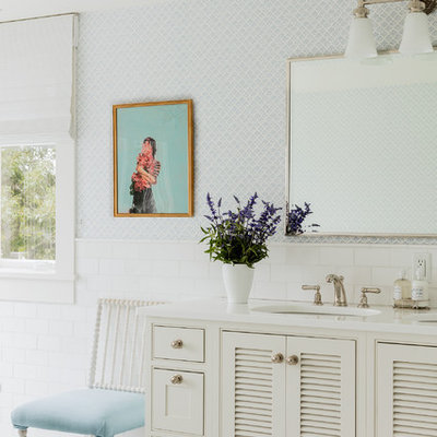 Elegant white tile bathroom photo in San Francisco with louvered cabinets, white cabinets, blue walls and an undermount sink