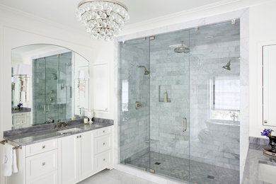 Example of a transitional master white tile marble floor bathroom design in Atlanta with shaker cabinets, white cabinets, white walls, an undermount sink, marble countertops and a hinged shower door