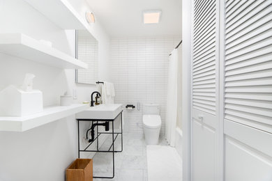 Example of a trendy white tile white floor bathroom design in New York with white walls and a console sink
