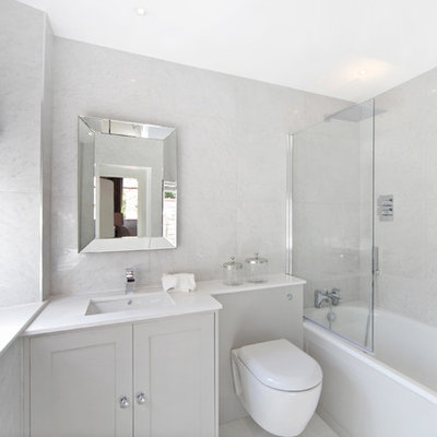 Small transitional master marble tile and gray tile bathroom photo in London with gray cabinets, a wall-mount toilet, gray walls, white countertops, shaker cabinets and an undermount sink
