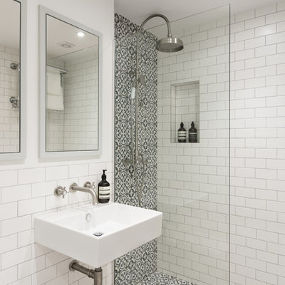 Example of a trendy 3/4 multicolored tile and white tile bathroom design in London with a wall-mount toilet, white walls and a wall-mount sink