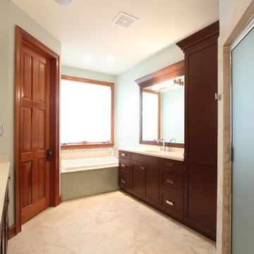 Cherry cabinets in Master Bathroom with built in bathtub