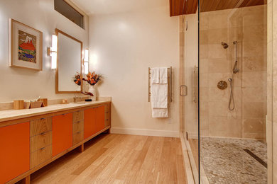 Bathroom - contemporary beige tile light wood floor bathroom idea in Denver with an undermount sink, flat-panel cabinets, orange cabinets and beige walls