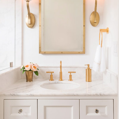 Alcove shower - small transitional master white tile and stone tile mosaic tile floor and white floor alcove shower idea in Boston with shaker cabinets, a wall-mount toilet, white walls, an undermount sink, marble countertops, white cabinets and a hinged shower door