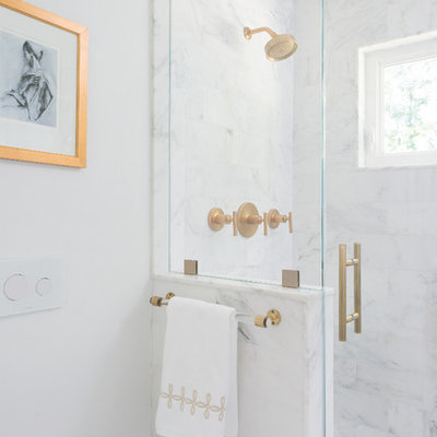 Inspiration for a small transitional master white tile and stone tile mosaic tile floor and white floor alcove shower remodel in Boston with shaker cabinets, white cabinets, a wall-mount toilet, white walls, an undermount sink, marble countertops and a hinged shower door