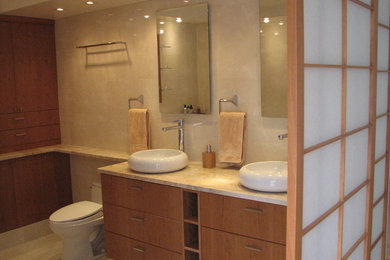 Example of a large minimalist master beige tile and porcelain tile porcelain tile bathroom design in DC Metro with flat-panel cabinets, medium tone wood cabinets, a one-piece toilet, a vessel sink, marble countertops and beige walls