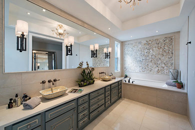 Bathroom - mid-sized coastal master multicolored tile and ceramic tile ceramic tile and beige floor bathroom idea in Tampa with furniture-like cabinets, blue cabinets, an undermount tub, beige walls, a vessel sink and soapstone countertops