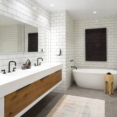 Example of a mid-sized transitional master white tile and subway tile gray floor and cement tile floor bathroom design in Chicago with flat-panel cabinets, medium tone wood cabinets, an integrated sink, white countertops and white walls