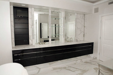 Example of a large minimalist master gray tile and stone tile marble floor freestanding bathtub design in Chicago with an undermount sink, flat-panel cabinets, black cabinets, marble countertops and white walls