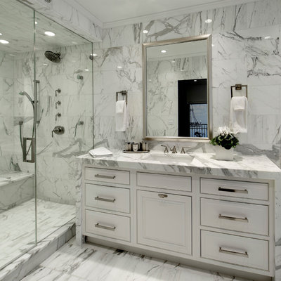 Inspiration for a mid-sized timeless master white tile and stone tile marble floor alcove shower remodel in Chicago with an undermount sink, white cabinets, marble countertops, raised-panel cabinets, a one-piece toilet and white walls