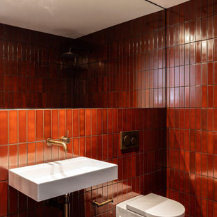 Design ideas for a contemporary bathroom in Sydney with a wall-mount toilet, red tile, a wall-mount sink, grey floor and a single vanity.