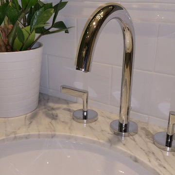 Chrome fixtures and a marble countertop bring a modern elegant finish.