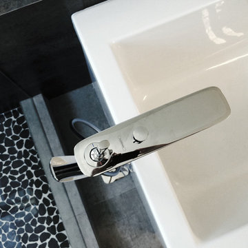 chrome freestanding tub filler at rectangular bath