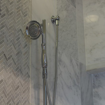 Chrome Shower Fixture in Marbled Tile Shower