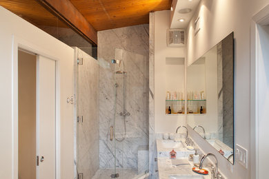 Corner shower - mid-sized 1950s master porcelain tile porcelain tile corner shower idea in Los Angeles with an undermount sink, flat-panel cabinets, white cabinets, marble countertops, an undermount tub, a one-piece toilet and white walls