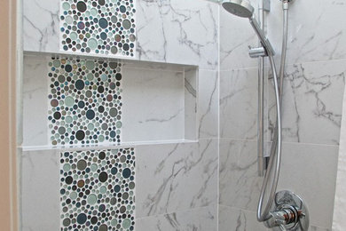 Inspiration for a small modern family bathroom in San Francisco with a submerged sink, freestanding cabinets, white cabinets, marble worktops, an alcove shower, a two-piece toilet, multi-coloured tiles, porcelain tiles, white walls and mosaic tile flooring.