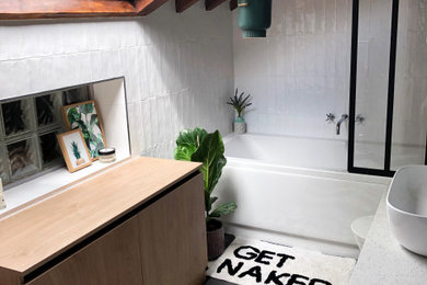 Design ideas for a small contemporary family bathroom in London with white tiles, white walls, cement flooring, a console sink, black floors and an open shower.