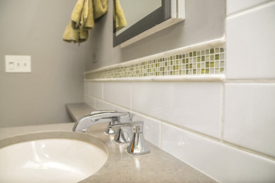 Example of a small transitional white tile and ceramic tile ceramic tile bathroom design in Chicago with an undermount sink, flat-panel cabinets, brown cabinets, quartz countertops, a one-piece toilet and gray walls