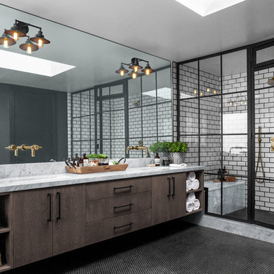 Wet room - large industrial master porcelain tile and white tile ceramic tile and black floor wet room idea with black walls, marble countertops, a hinged shower door, gray countertops, flat-panel cabinets, dark wood cabinets and an undermount sink
