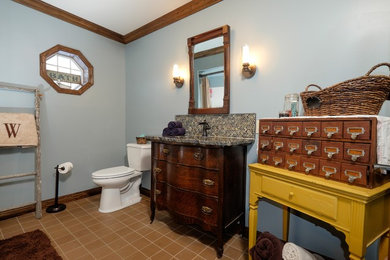 Mid-sized farmhouse master multicolored tile and glass tile terra-cotta tile bathroom photo in Minneapolis with an undermount sink, furniture-like cabinets, dark wood cabinets, granite countertops, a one-piece toilet and blue walls