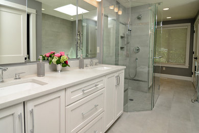 Example of a mid-sized classic master gray tile and ceramic tile ceramic tile bathroom design in Portland with recessed-panel cabinets, white cabinets, gray walls, an undermount sink and solid surface countertops