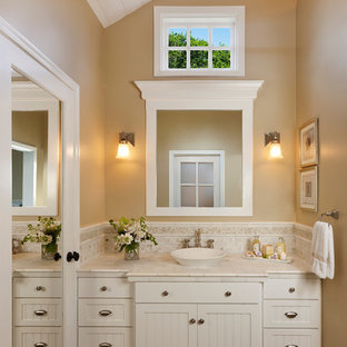Elegant bathroom photo in Santa Barbara with marble countertops, a vessel sink and white countertops
