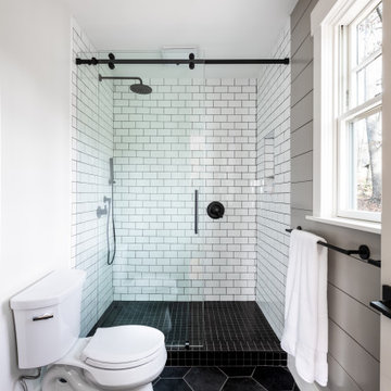 Classic black and white master bathroom with antique vanity