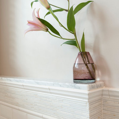 Example of a mid-sized classic master white tile and subway tile marble floor corner shower design in New York with an undermount sink, raised-panel cabinets, white cabinets, marble countertops, a wall-mount toilet, beige walls and an undermount tub