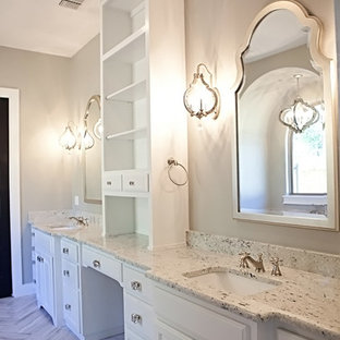 This is an example of a large arts and crafts master bathroom in Austin with furniture-like cabinets, white cabinets, a freestanding tub, a curbless shower, a two-piece toilet, white walls, concrete floors, an undermount sink, granite benchtops, brown tile and ceramic tile.