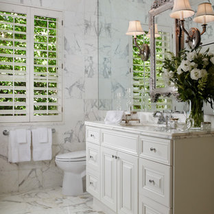 Large elegant master white tile and marble tile marble floor and white floor bathroom photo in Miami with raised-panel cabinets, white cabinets, gray walls, an undermount sink and marble countertops