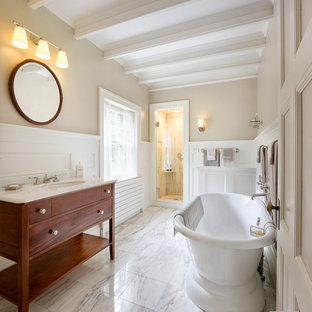 Elegant white tile and stone tile bathroom photo in Boston with an undermount sink, medium tone wood cabinets, marble countertops and flat-panel cabinets