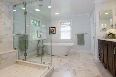Example of a large transitional master porcelain tile marble floor bathroom design in Boston with recessed-panel cabinets, brown cabinets, a one-piece toilet, an undermount sink and a hinged shower door