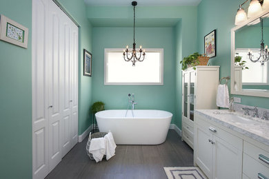 Inspiration for a large coastal master vinyl floor and gray floor bathroom remodel in Seattle with recessed-panel cabinets, white cabinets, green walls, an undermount sink, marble countertops and gray countertops