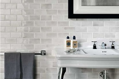 Example of a mid-sized trendy 3/4 white tile and ceramic tile ceramic tile and gray floor bathroom design in New York with black walls and a console sink